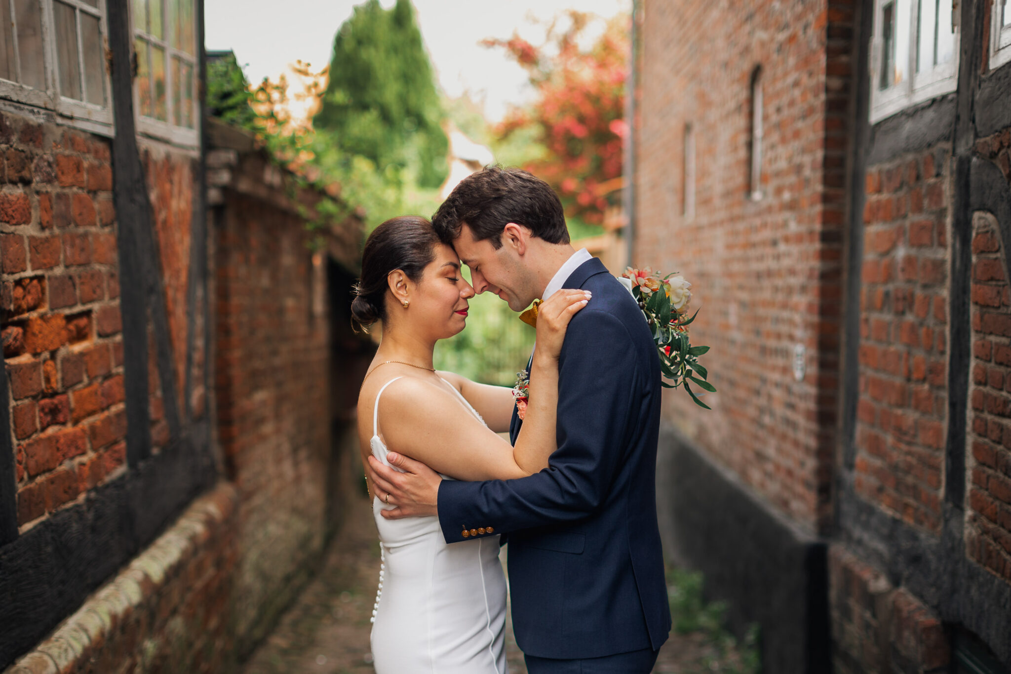 Bride and groom holding hands in a romantic alleyway