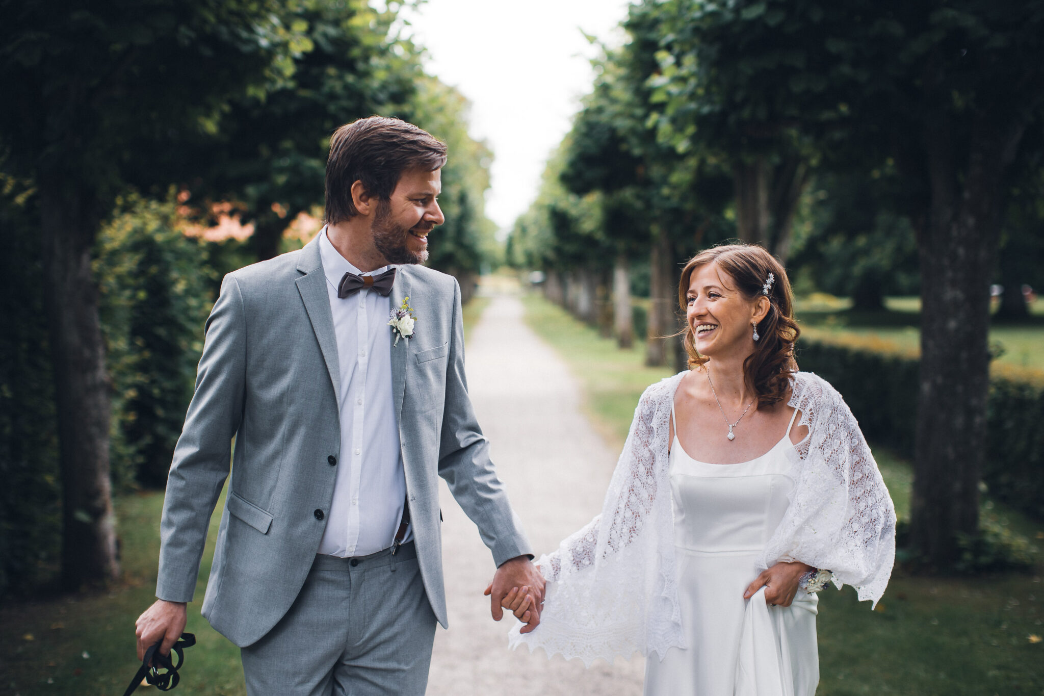 Newlyweds strolling down a scenic path on their wedding da