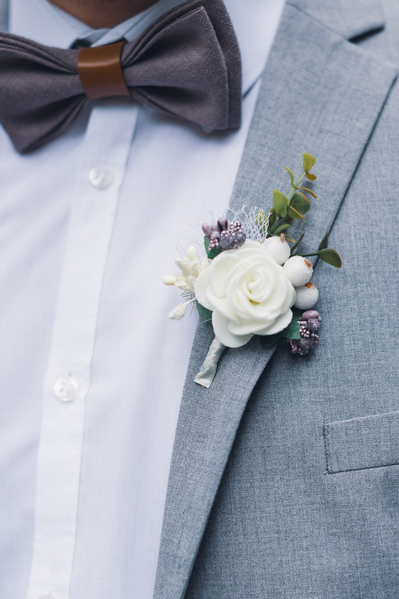 A man in a suit with a boutonniere, looking sharp and elegant