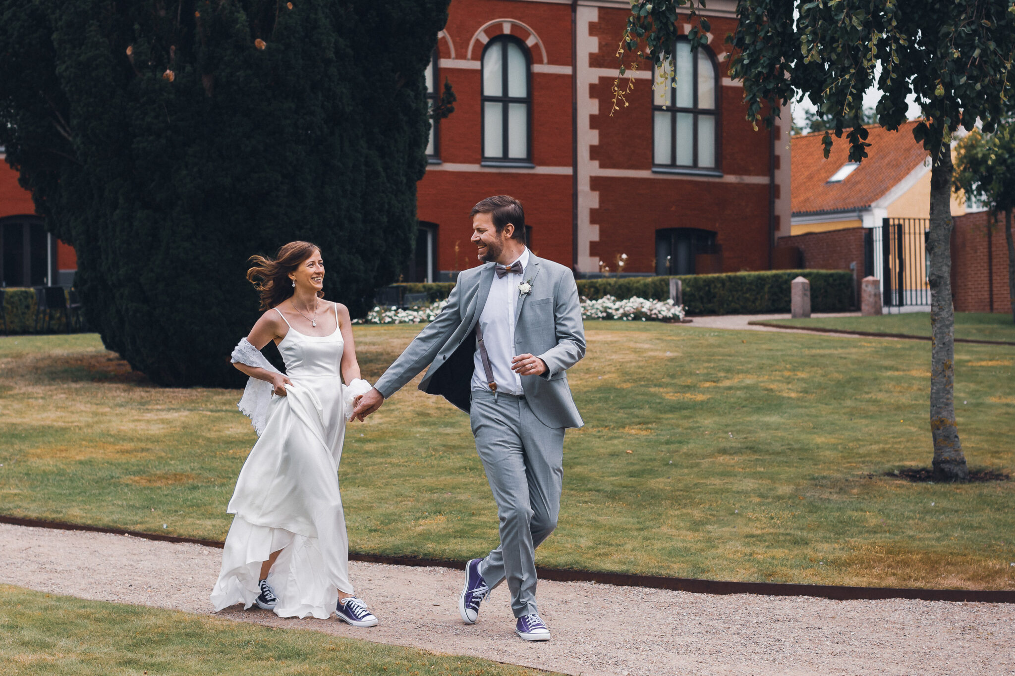 Bride and groom walking together near building
