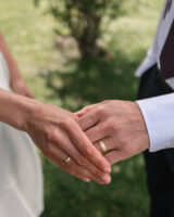 A close-up image of a man and woman gently holding hands, symbolizing connection and intimacy between them.